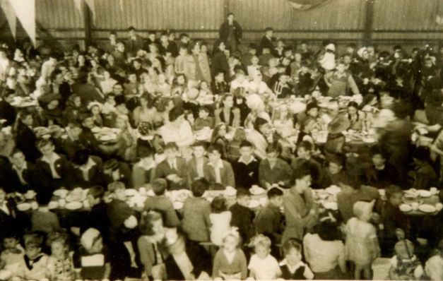 Children's tea party at wick, children gather in the Badmington club along long tables for tea.