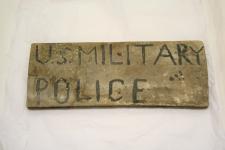a wooden sign with US Military Police painted on it