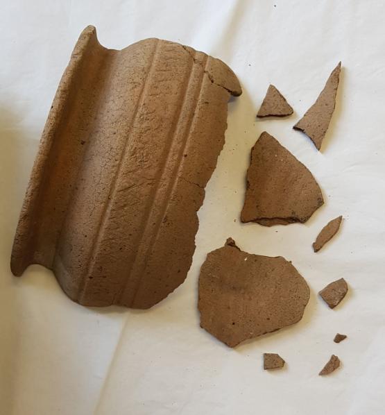the shoulder and some fragments of a large ceramic vessel. The decoration is very plain and primitive. 