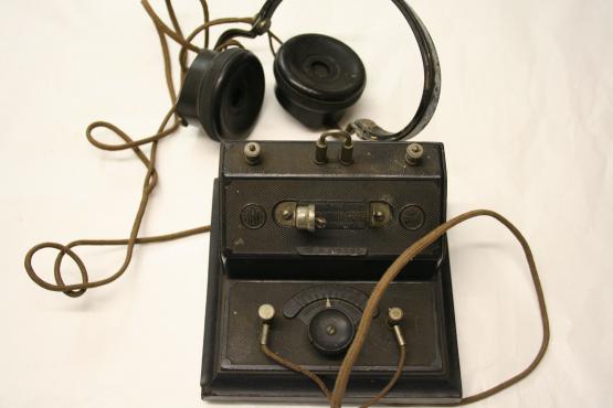 a crystal radio set with earphones and wires visible