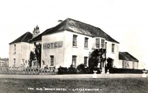 A black and white image showin a white building with a sign reading Hotel on the front. The photograph is captioned The Old Beach Hotel Littlehampton